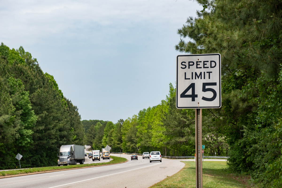 A 45 mph speed limit sign on a busy stretch of road